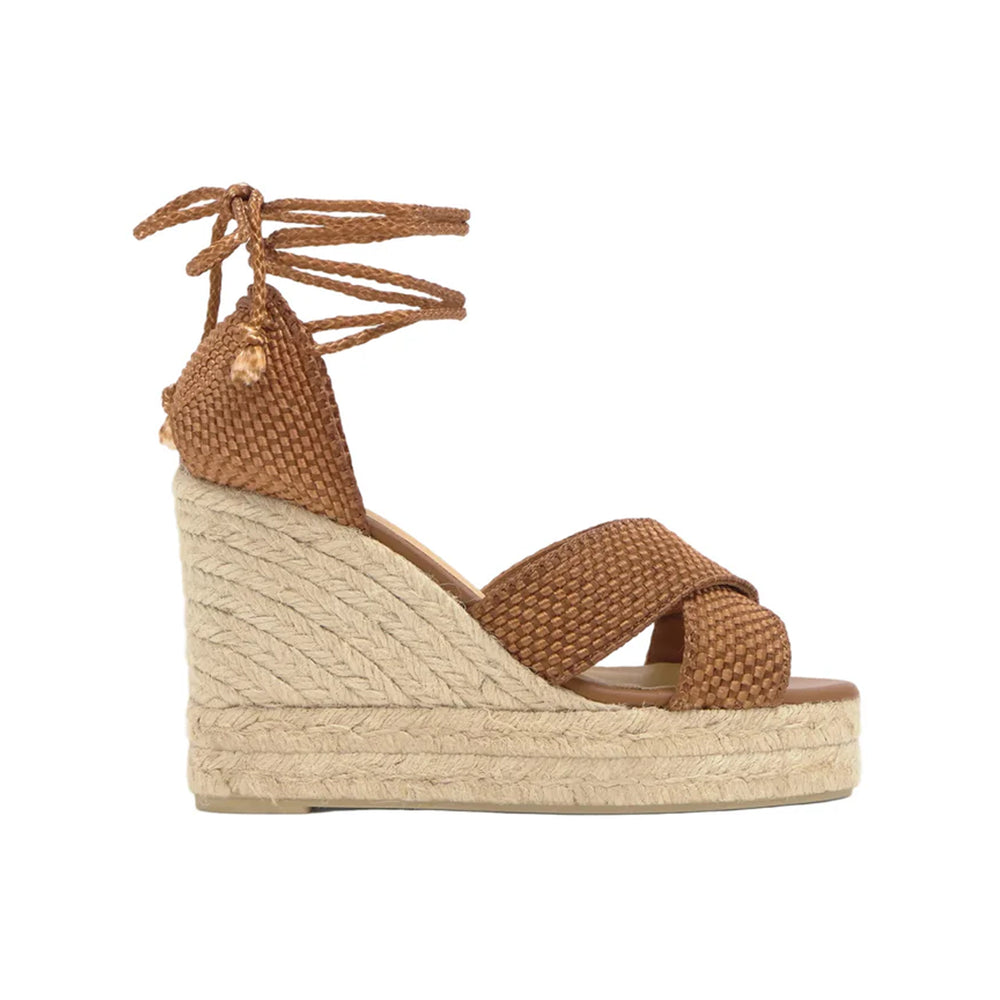 Side view of Becca 8ED wedge sandal with woven brown straps, lace-up ankle ties, and braided jute espadrille platform on white background