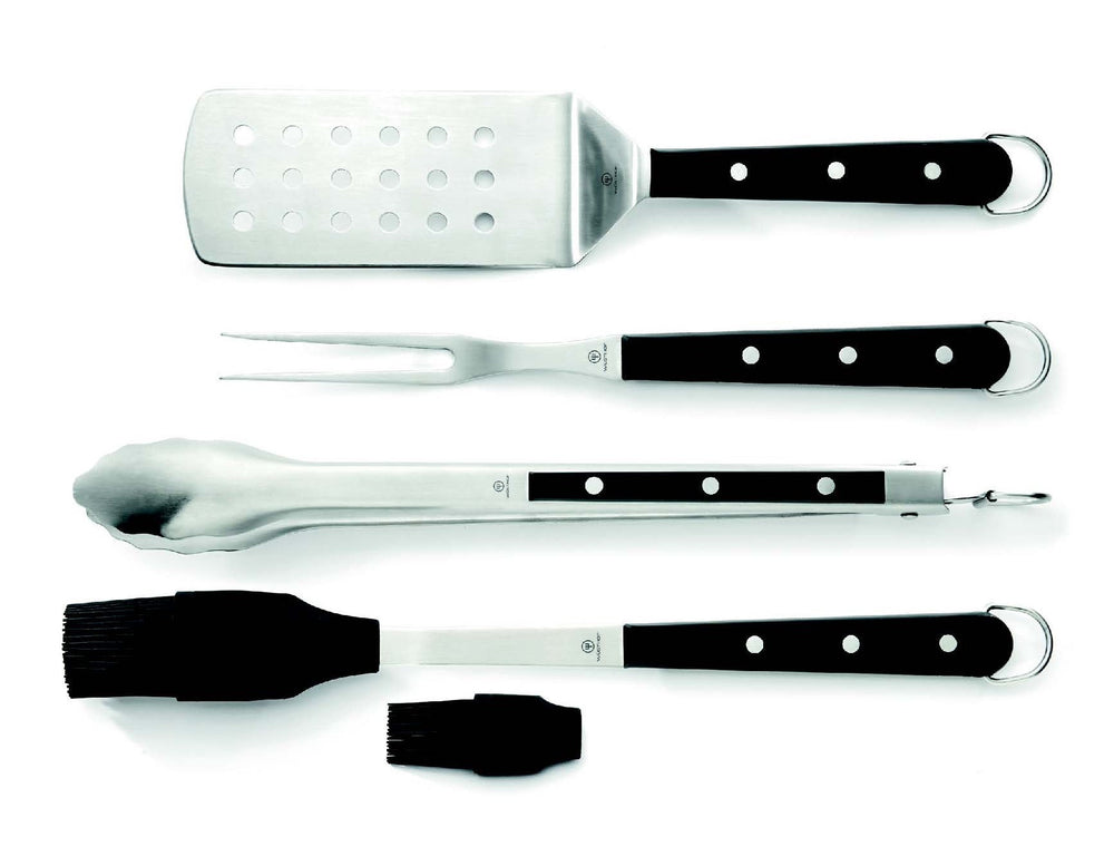 Top-down view of 4-piece BBQ set with perforated spatula, meat fork, tongs and silicone brush with extra head on white