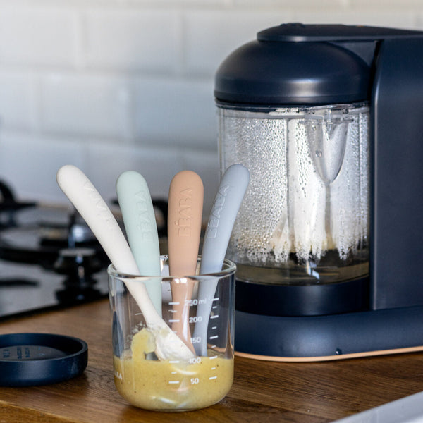 Close-up of four First Stage silicone spoons in Natural with long handles and soft tips in puree