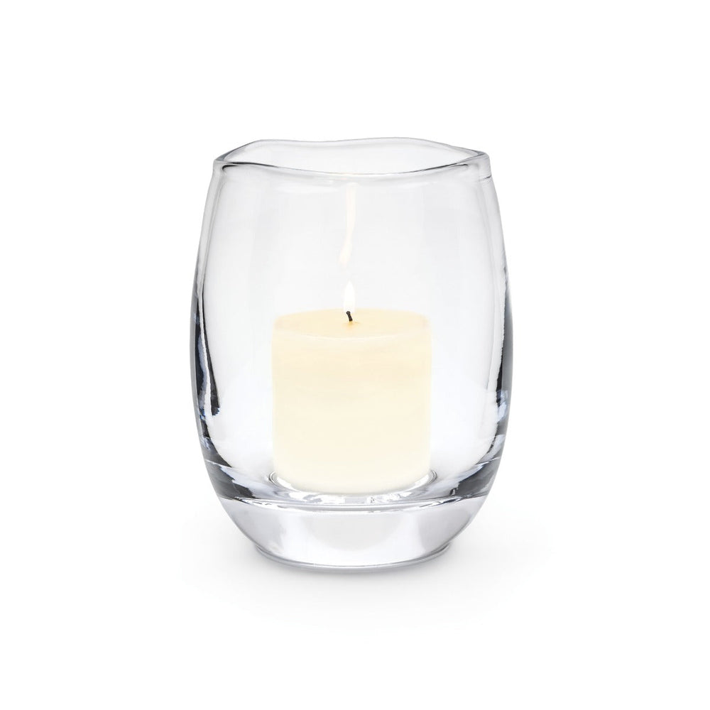 Front view of Burlington Hurricane glass with lit pillar candle, handblown organic rim on white background