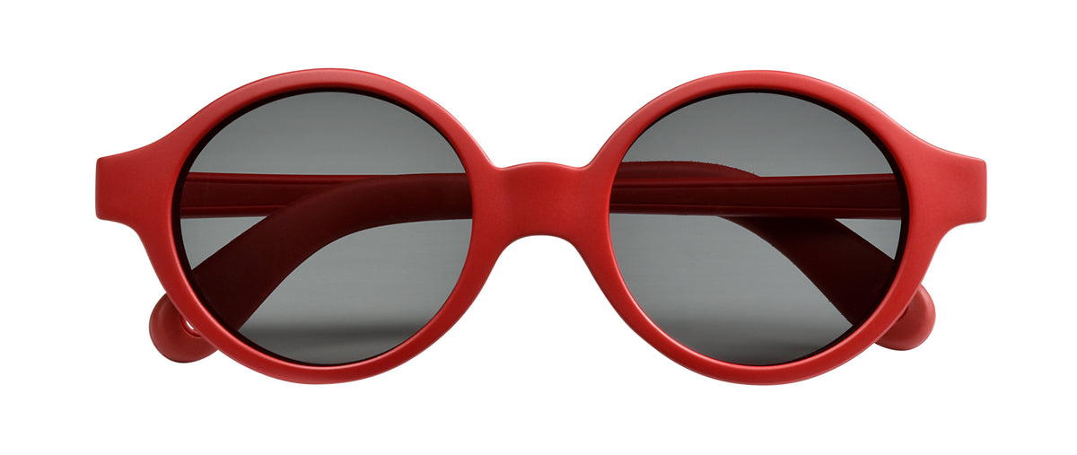 Front view of Joy Infant Sunglasses in Poppy Red showcasing gray lenses and red frames with a white background