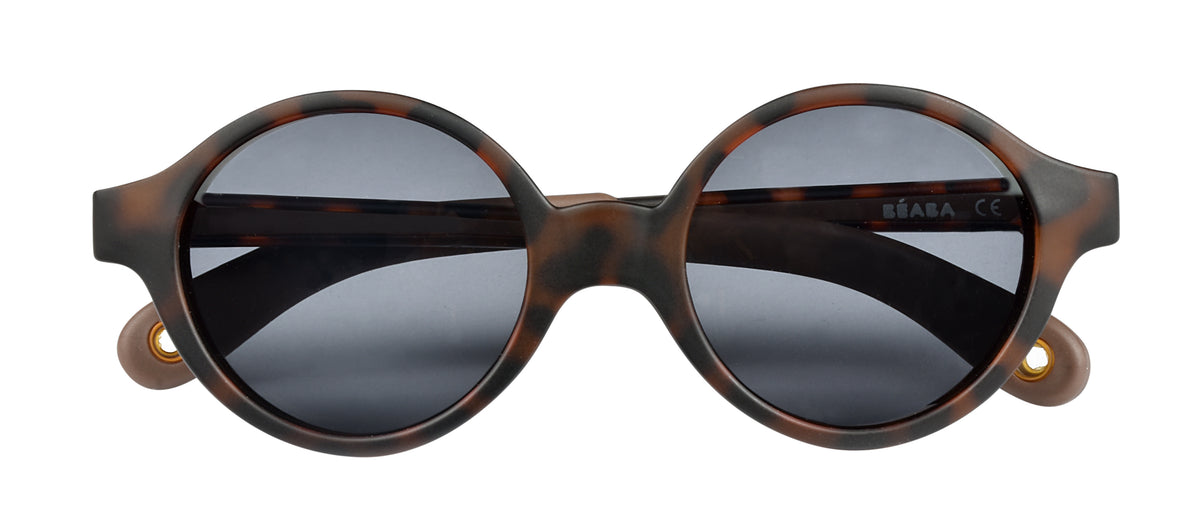 Close-up front view of Joy Infant Sunglasses in Tortoise showcasing dark lenses and side shells on a white background
