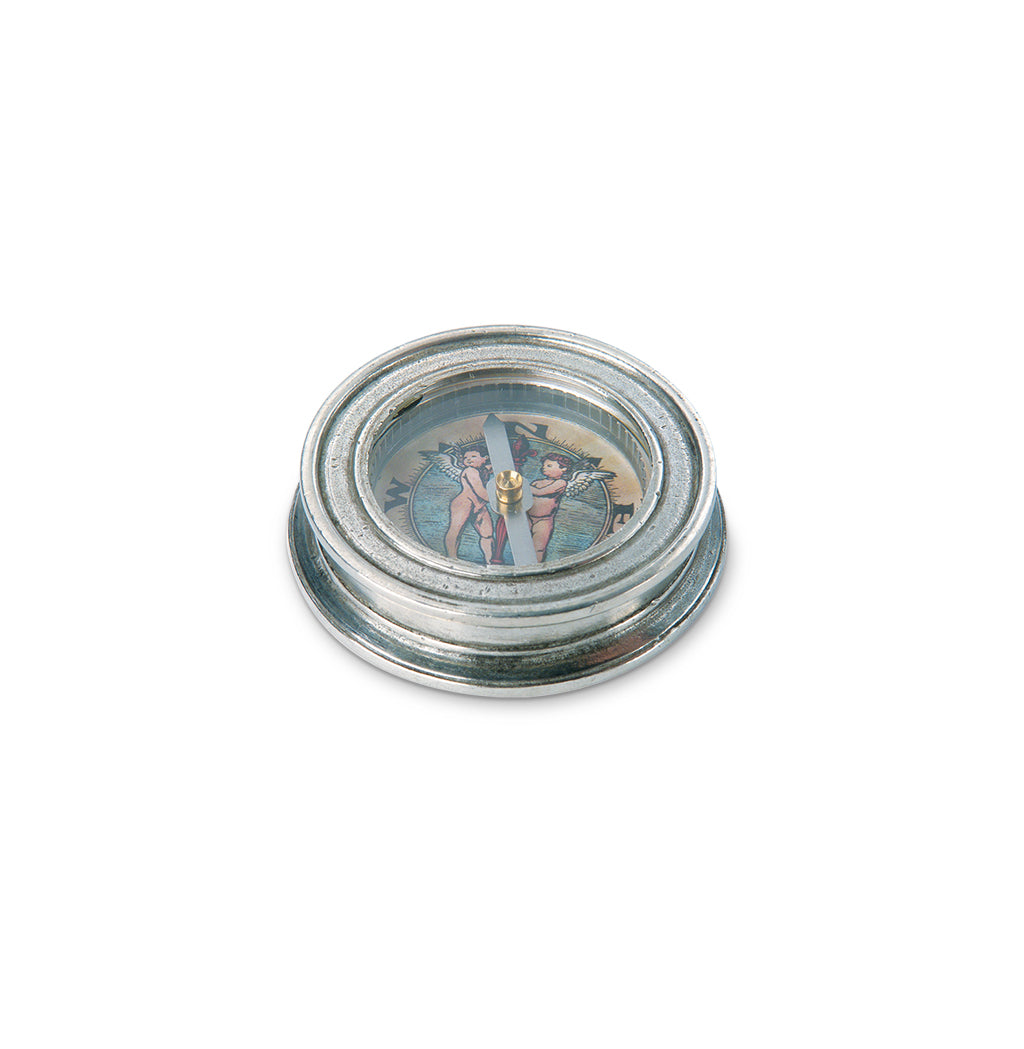 Angled top view of Match Compass pewter compass showcasing cherub illustration on the dial with white background