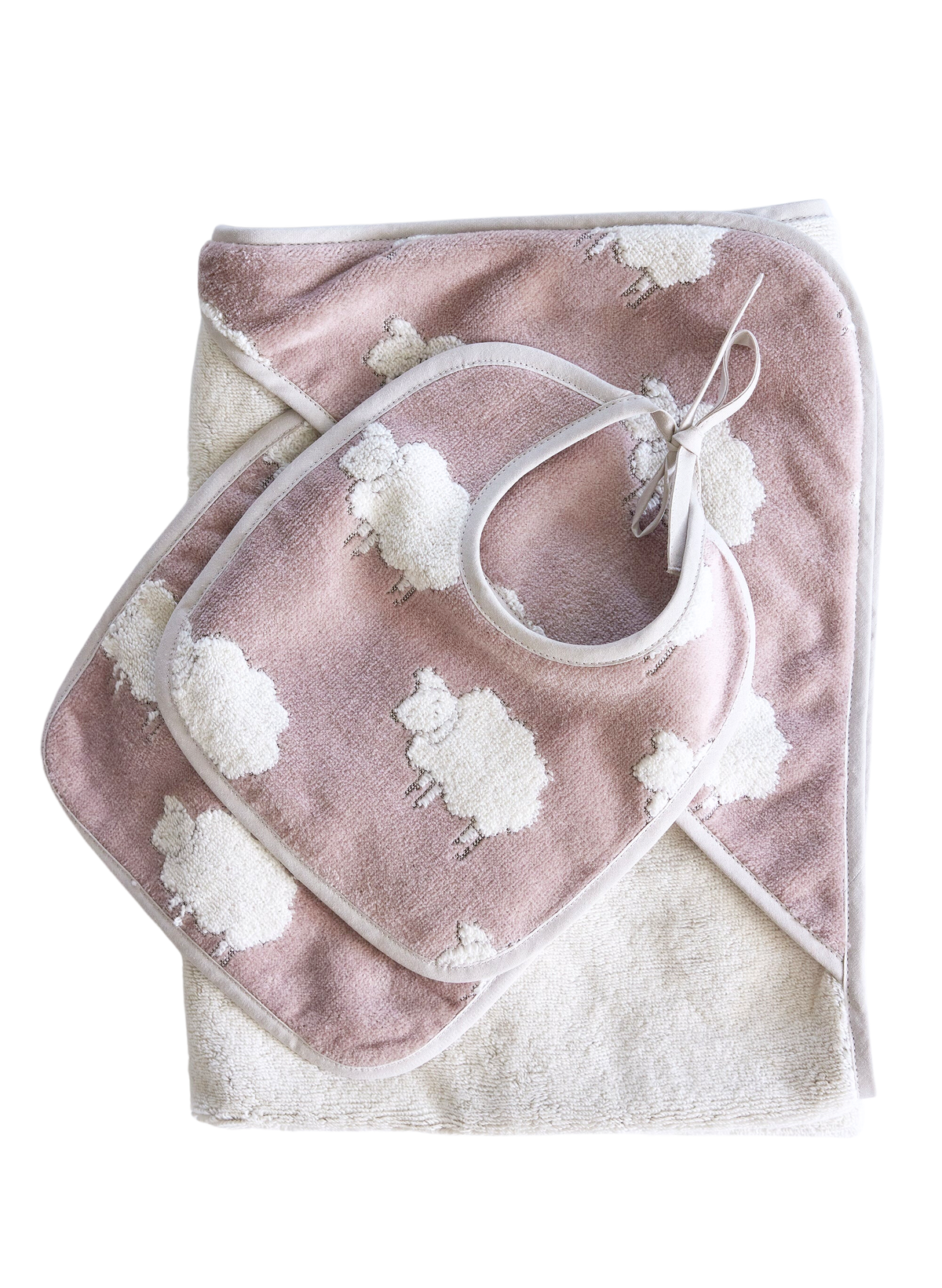 Overhead view of Sweet Sheep Jacquard Bath Set showcasing pink sheep pattern, hooded towel and washcloth on black background