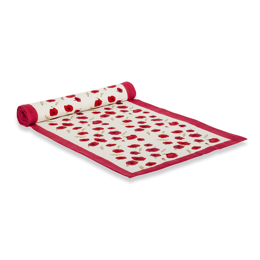 Angled view of Poppies Runner showcasing red poppy and leaf pattern with rolled section and red border on white background