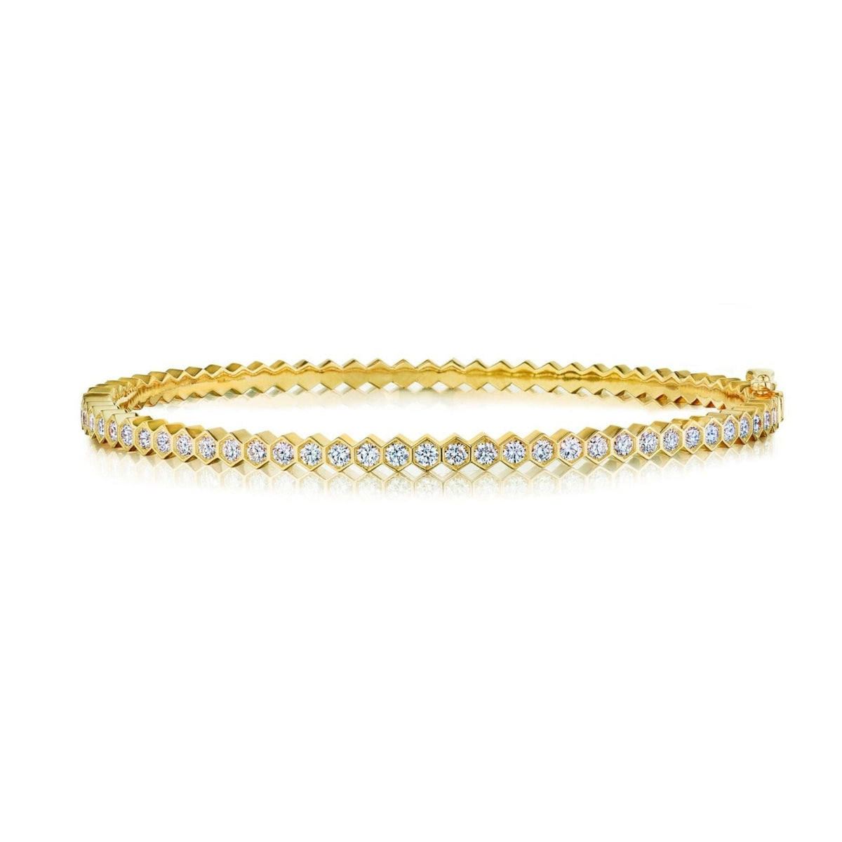 The Hexagon Bezel Set Diamond Bangle showcases a single row of round white diamonds in 18k gold, featuring a secure clasp and reflective underside for extra brilliance.