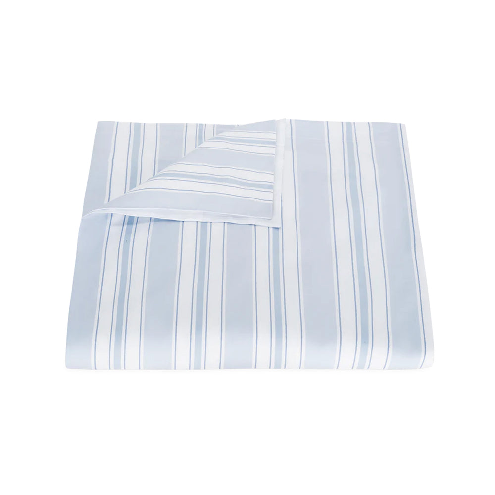Folded view of Elio Duvet Cover showcasing blue-and-white hand-drawn vertical stripes with a flipped corner revealing the reverse on a white background