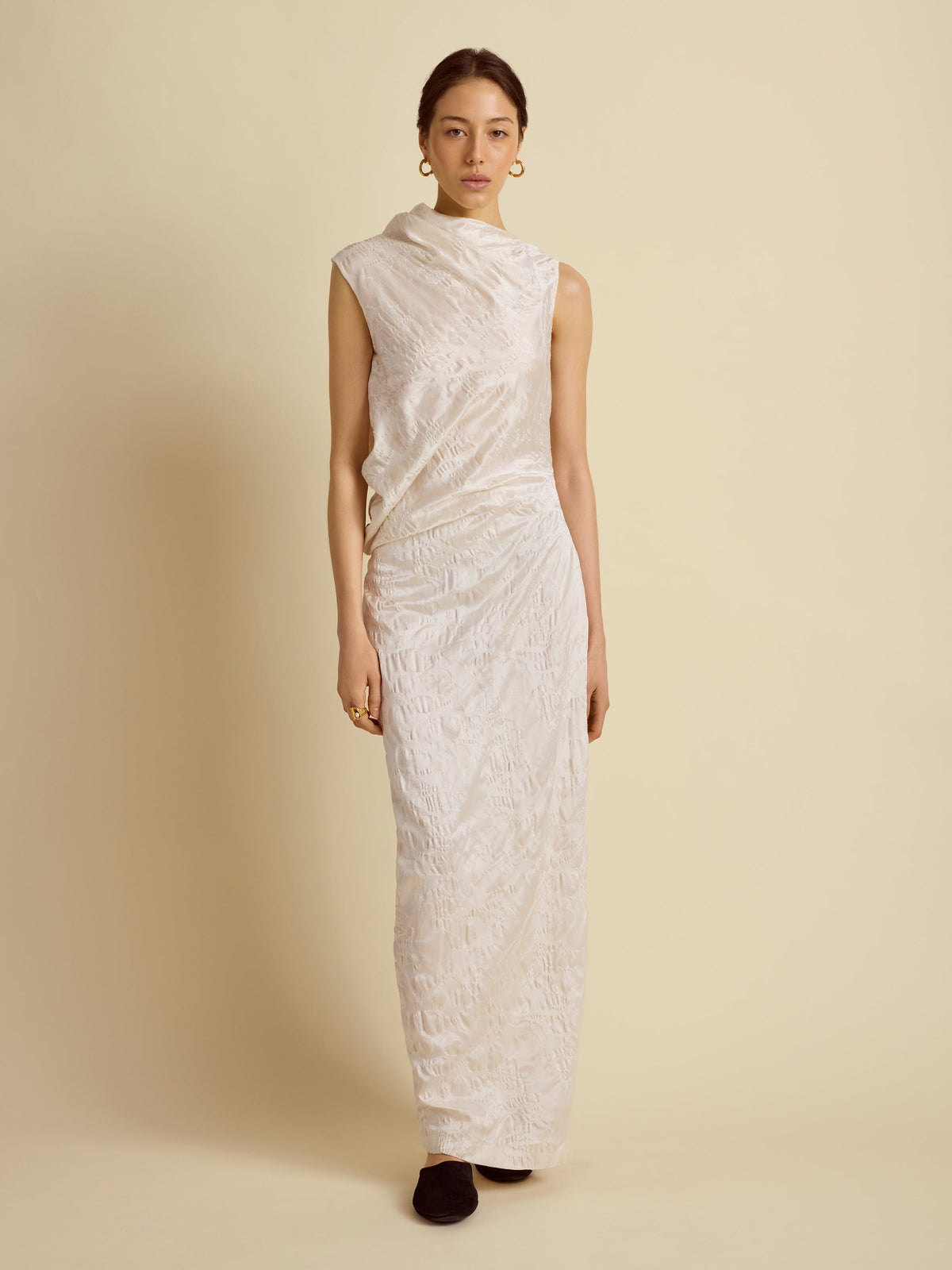 Front view of Satin Jacquard Column Dress in Ivory showcasing asymmetric drape on a model against a beige background
