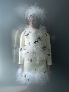 Front view of Emily Jacket showcasing white feather trim with black feather accents on a model against a dark background