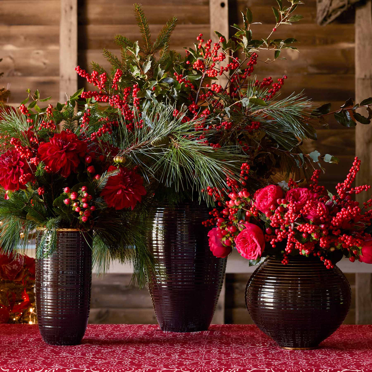AERIN Calinda Tall, Tapered and Moon Vases in Chocolate with holiday arrangements