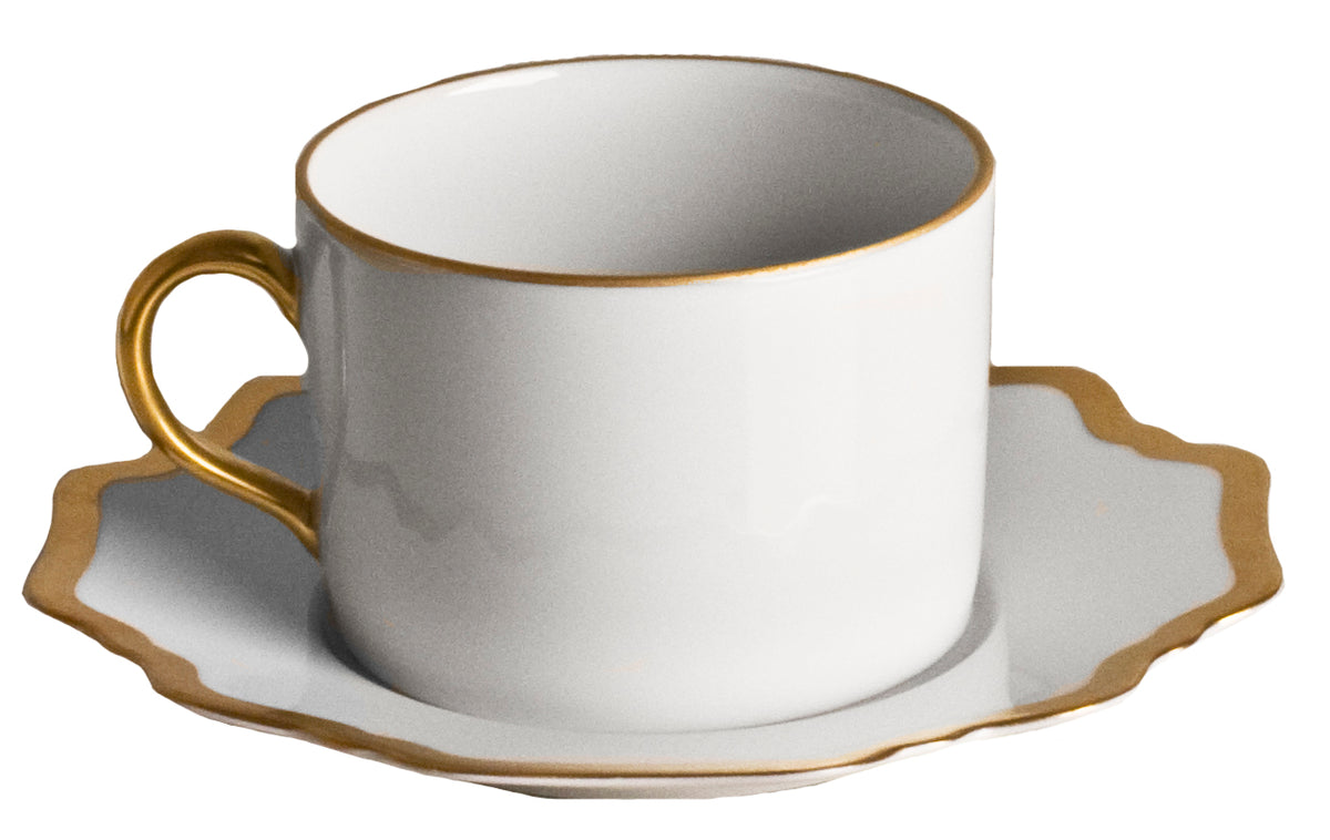 Front view of Antique White Tea Saucer in Gold Rim with scalloped gold rim and teacup on white background