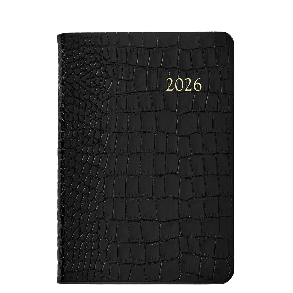 Front view of 2026 Embossed Crocodile Leather Journal showing black crocodile-embossed cover with gold-foil 2026 on white