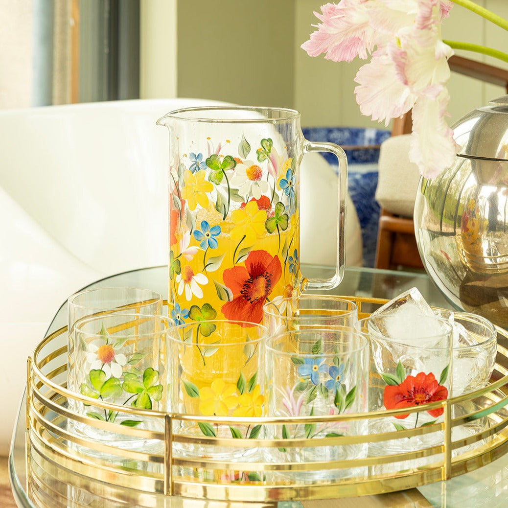 Front view of Scottish Wildflowers jug with hand-painted floral design on gold tray with matching glasses