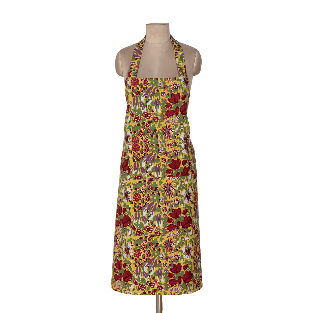 Front view of Jardin Apron Red & Green showcasing its colorful floral pattern and neck straps on a mannequin against a white background