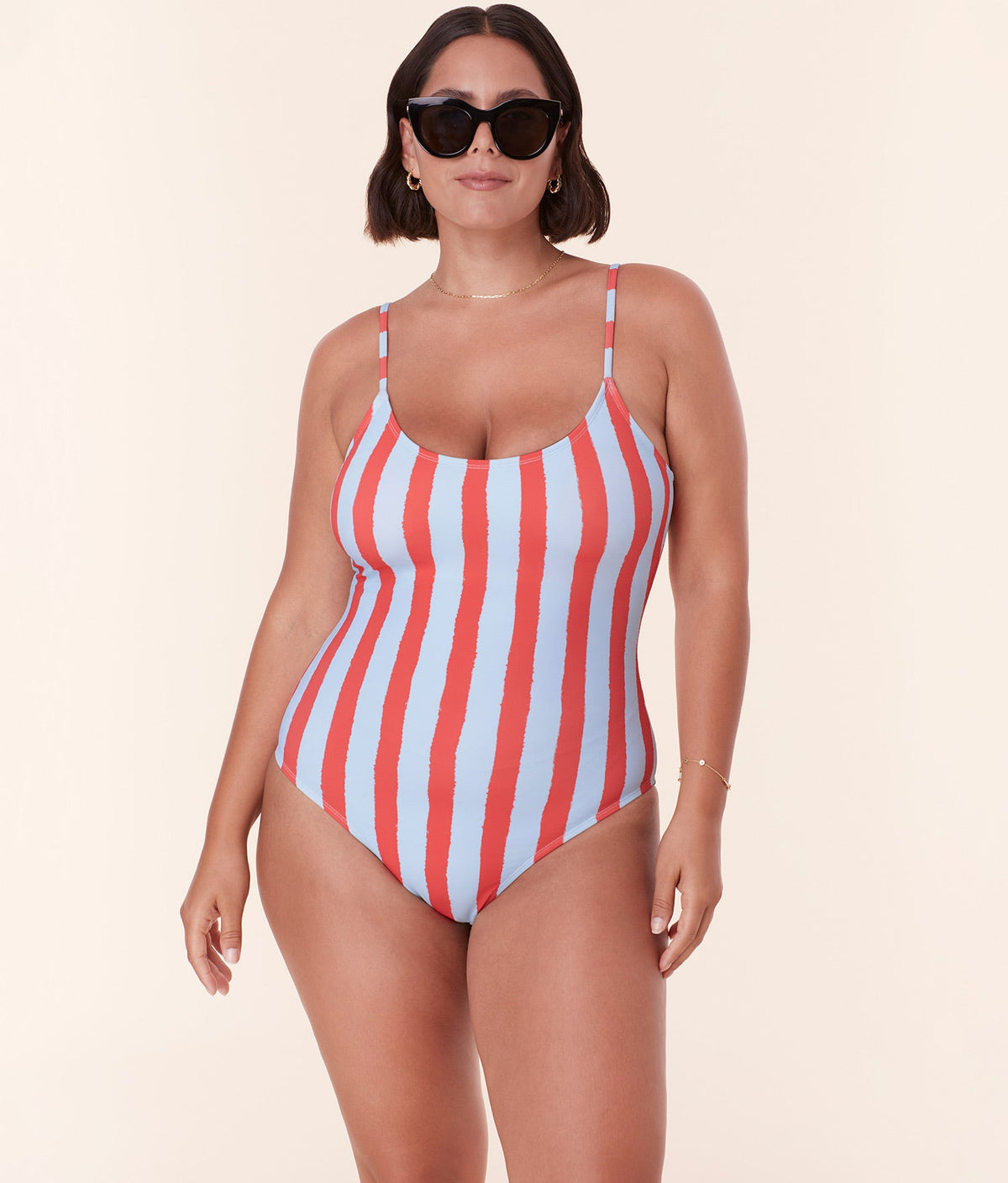 Side profile of model in Andie Swim’s Amalfi One Piece - Eco Nylon - Candy Stripe with sculpting fit and scoop neckline.