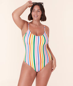 Model wearing Andie Swim’s Amalfi One Piece in vibrant Rainbow Stripe with a flattering scoop neckline and adjustable straps.