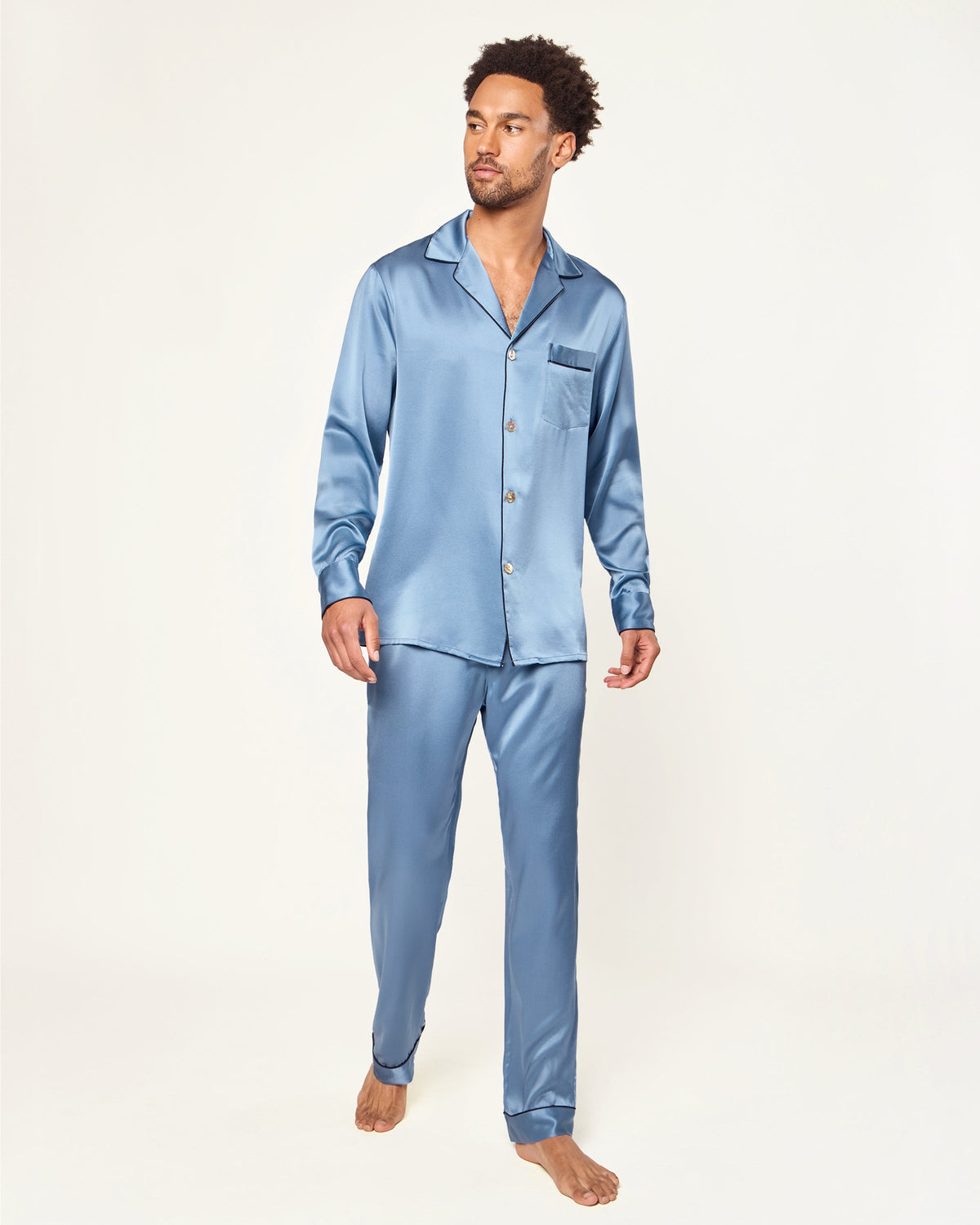 Front view of Men’s Silk Pajama Set in Mystique Blue showcasing contrast piping and chest pocket on a model against a light background