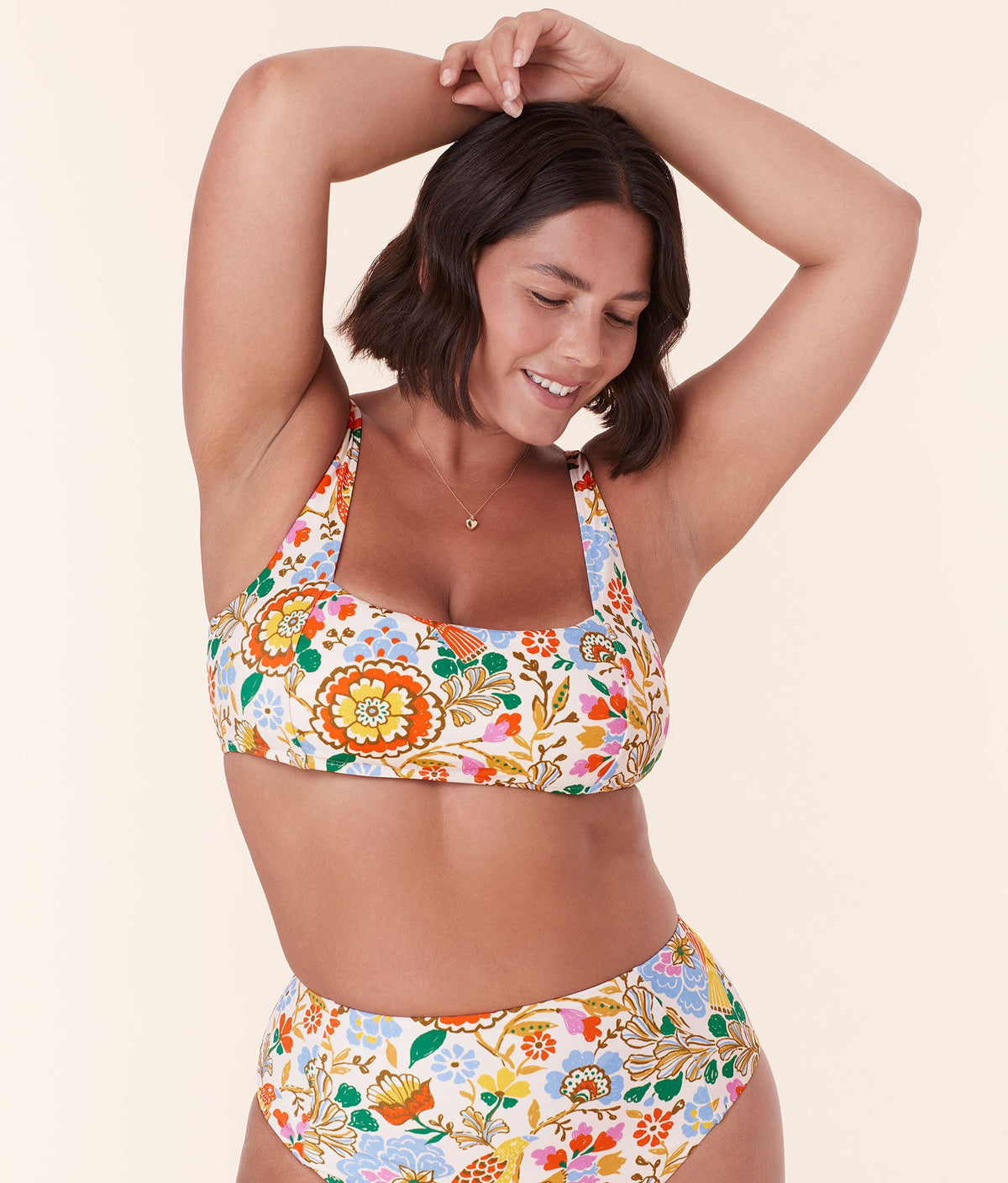 Model wearing Andie Swim's Havana Bikini Top in Bird Floral, showcasing the vintage-inspired low square neckline and flattering bust seams.