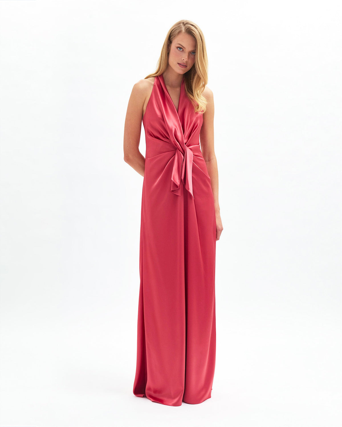 Front view of Ava Gown in coral on model showing plunging neckline and waist drape against white background