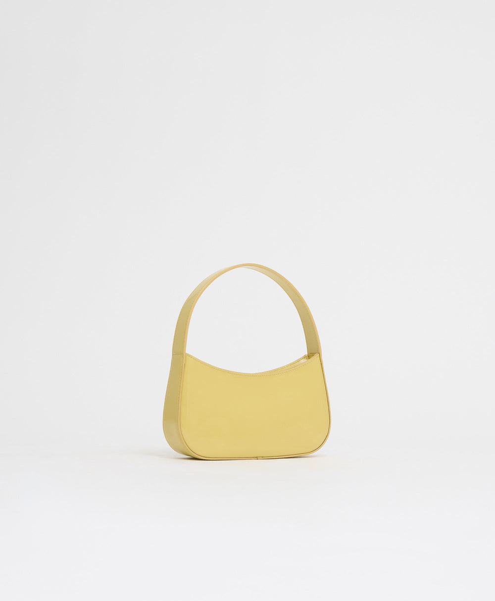 Front view of BonBon Bag in Naples showcasing glossy Spazzolato leather and rounded top handle on white background