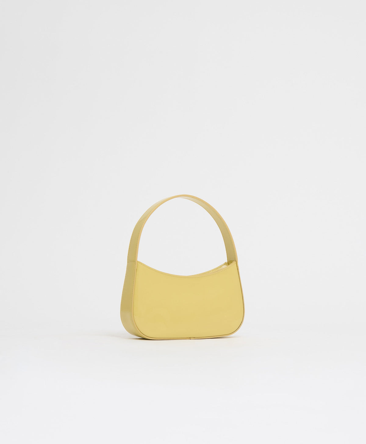 Front view of BonBon Bag in Naples showcasing glossy Spazzolato leather and rounded top handle on white background