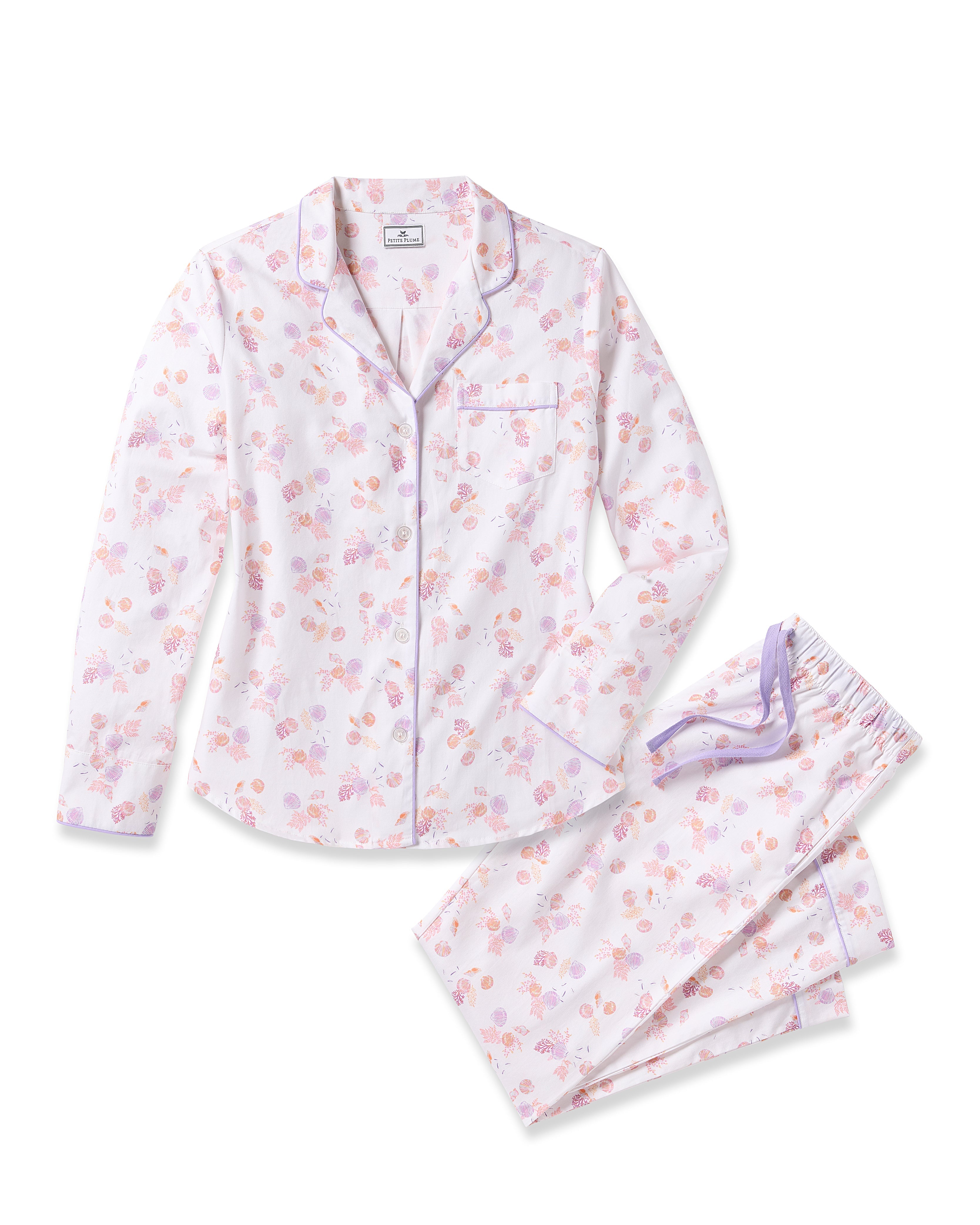 Indulge in luxury with Petite Plumes Womens Twill Pajama Set in Seashell Splendor, featuring yarn-dyed white cotton adorned with pink and purple floral patterns. This set includes a long-sleeve button-up top with a collar and chest pocket, plus matching pants with a purple drawstring.