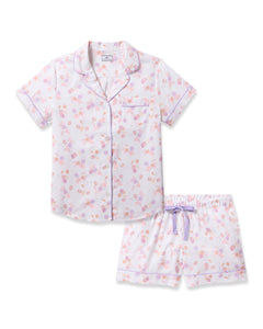 Indulge in luxurious sleep with Petite Plumes Womens Twill Short Sleeve Short Set in Seashell Splendor, showcasing pastel florals on high-quality cotton. The button-up top has a small pocket and purple piping, while the shorts feature an elastic waistband with a purple bow.