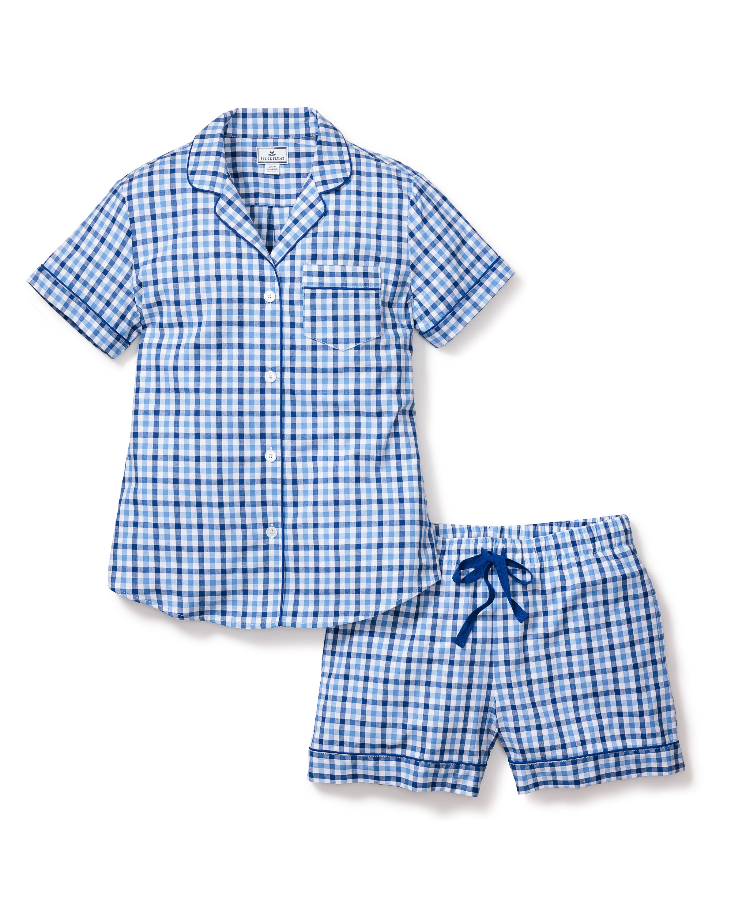 Enjoy supreme comfort with the Womens Twill Pajama Short Sleeve Short Set in Royal Blue Gingham by Petite Plume. This luxury sleepwear features a short-sleeved button-up top with a chest pocket and matching shorts with a drawstring waist, perfect for enhancing your bedtime routine.