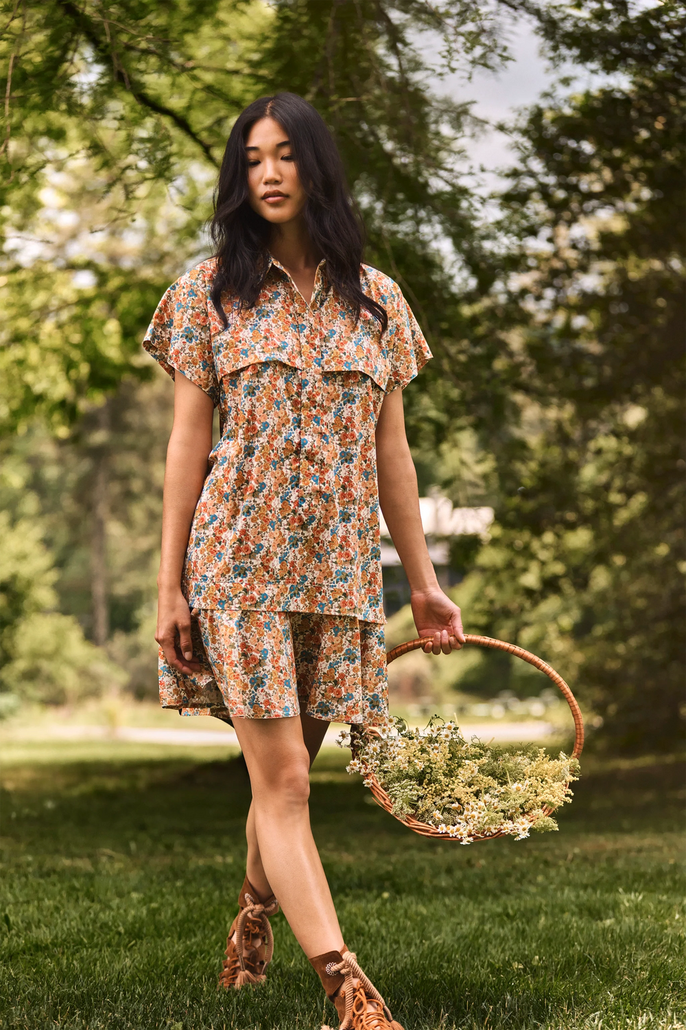 The Addison Dress, Made with Liberty Fabric floral dress, carrying a basket of florals.