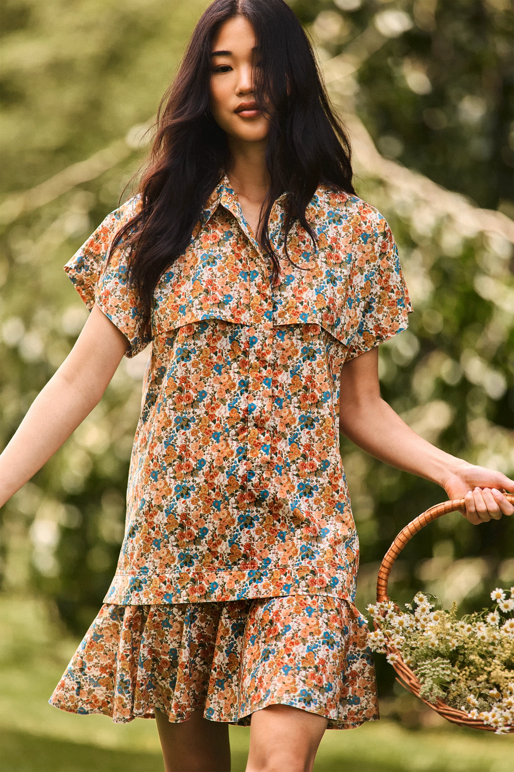 The Addison Dress, Made with Liberty Fabric floral dress, carrying a basket of florals.