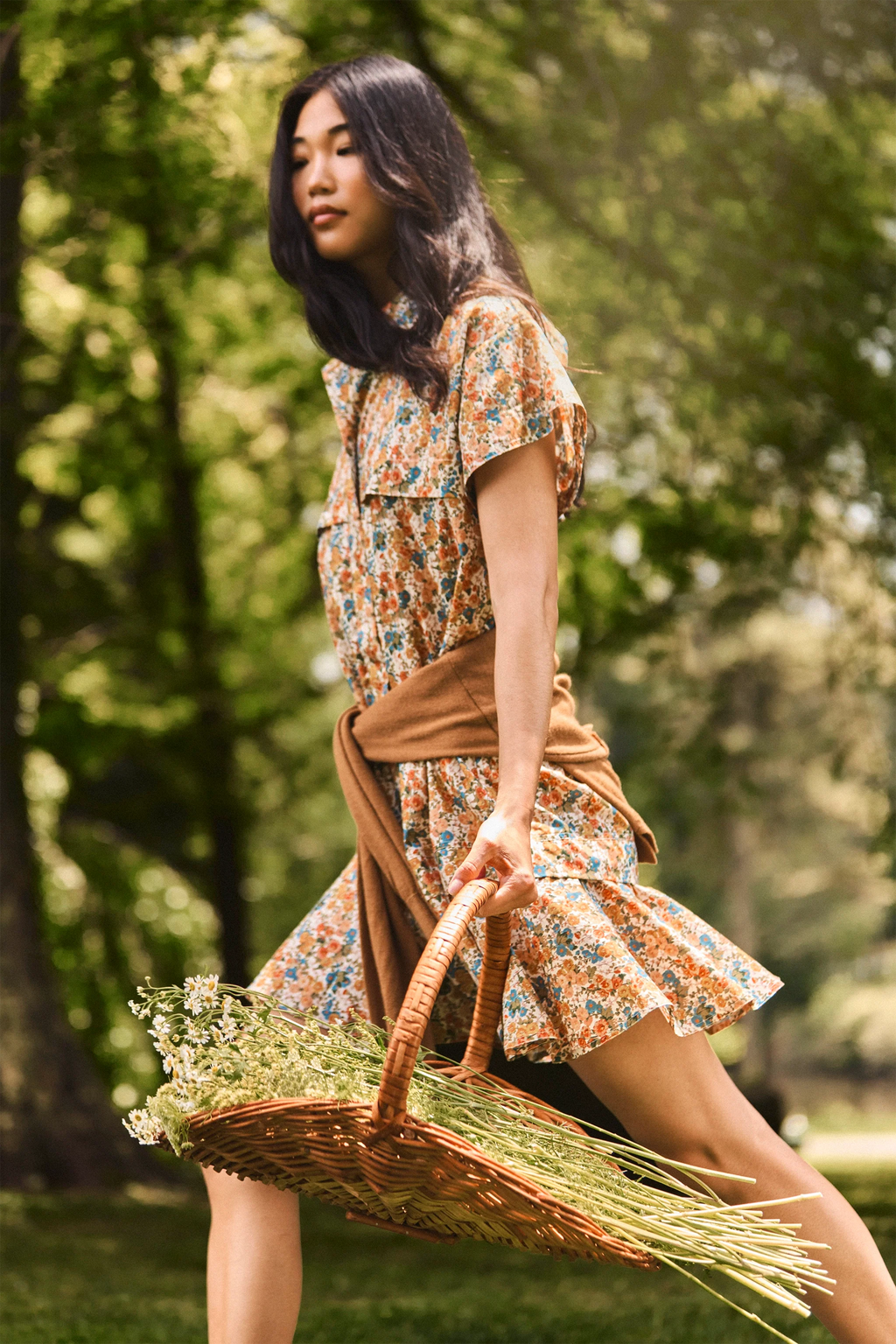 The Addison Dress, Made with Liberty Fabric floral dress, carrying a basket of florals.