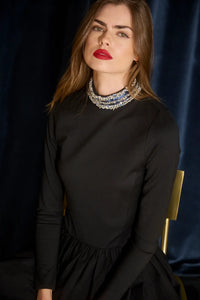 The Alexandra Dress is a fitted bodice with long sleeves, bubble skirt, and jeweled trim neckline. 