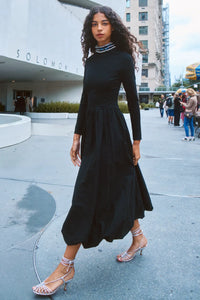 The Alexandra Dress is a fitted bodice with long sleeves, bubble skirt, and jeweled trim neckline. 