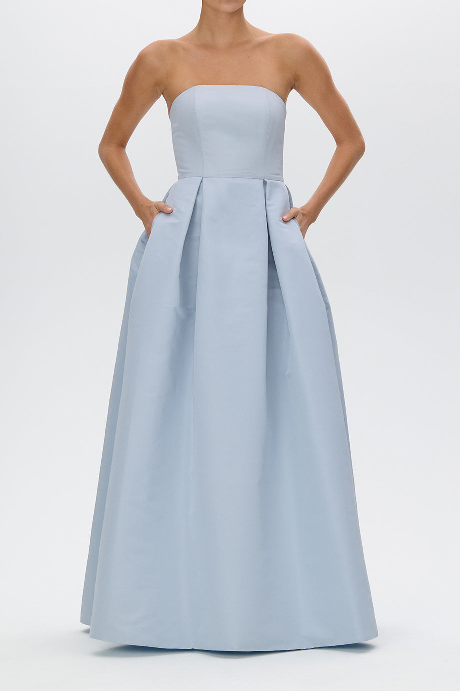 Front view of Alice Silk Faille gown showing strapless bodice, box-pleated full skirt and side pockets on white background