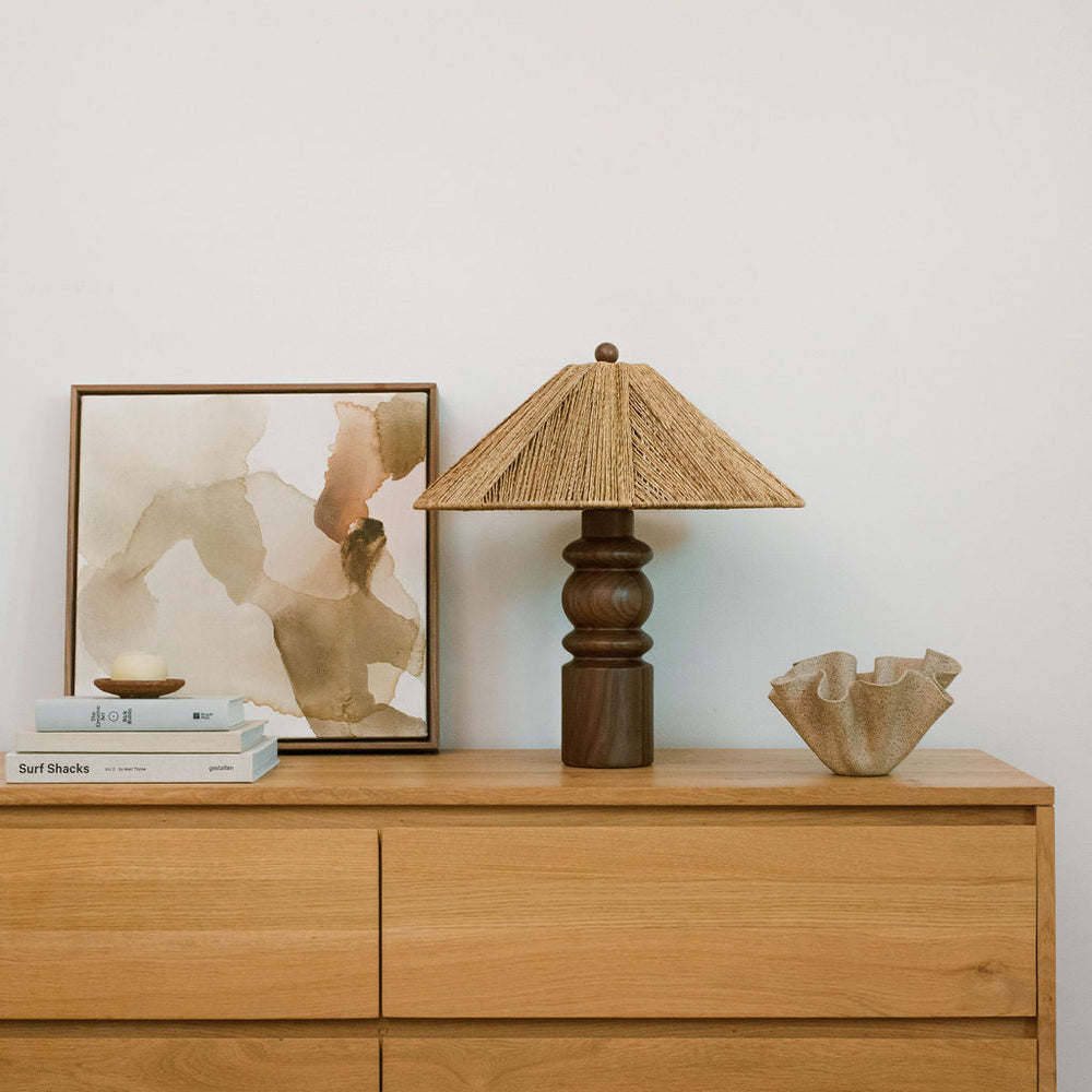 table lamp on dresser next to books