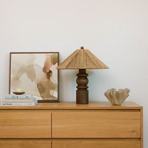 table lamp on dresser next to books