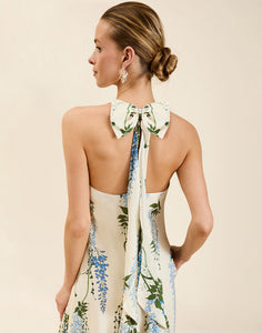 Adelina Gown in Wisteria Toile stretch crepe with halter neckline, cascading bow back detail, A-line silhouette, and hidden side pockets.