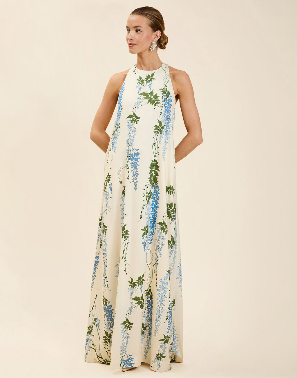 Adelina Gown in Wisteria Toile stretch crepe with halter neckline, cascading bow back detail, A-line silhouette, and hidden side pockets.