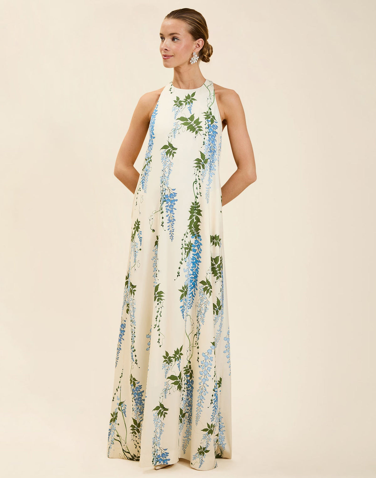 Adelina Gown in Wisteria Toile stretch crepe with halter neckline, cascading bow back detail, A-line silhouette, and hidden side pockets.