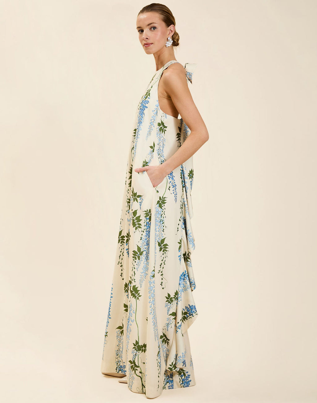 Adelina Gown in Wisteria Toile stretch crepe with halter neckline, cascading bow back detail, A-line silhouette, and hidden side pockets.