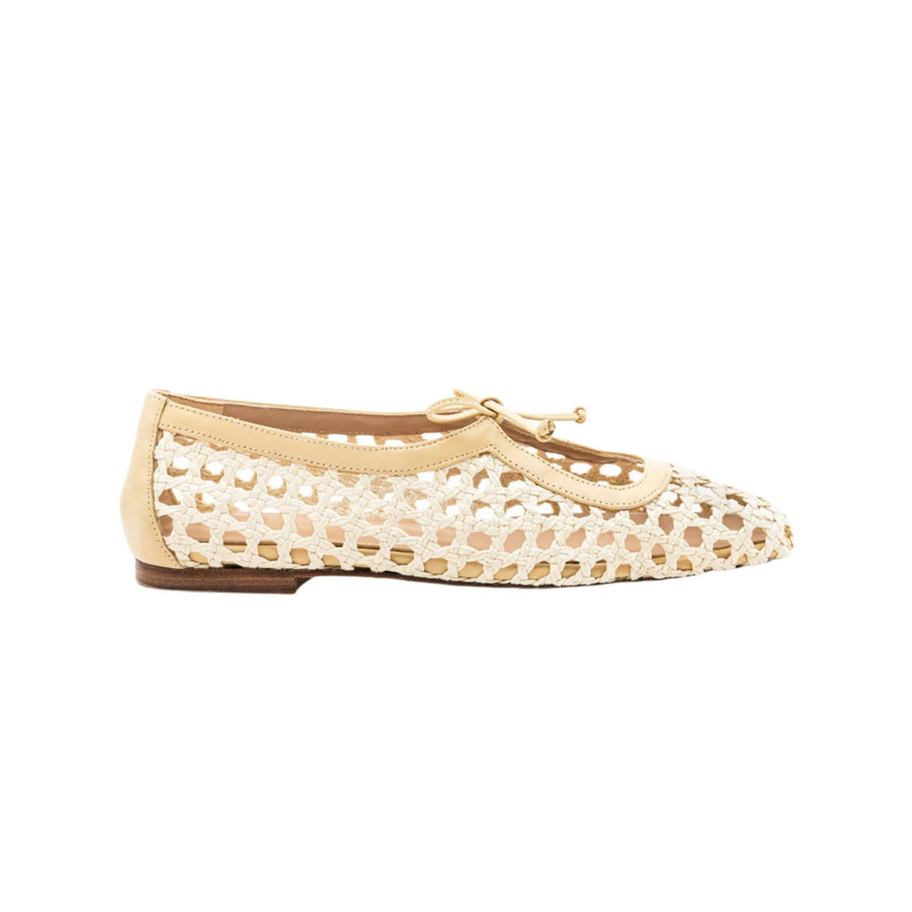 Side view of Amelia Flat in Natural Raffia showcasing woven raffia upper, vamp strap, and bow with white background
