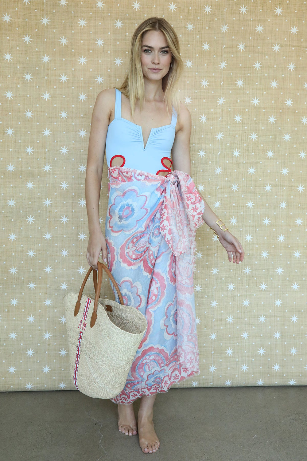 Model wearing Americana Willow pareo, showing hand-painted red, white and blue clover motif and fringed edge