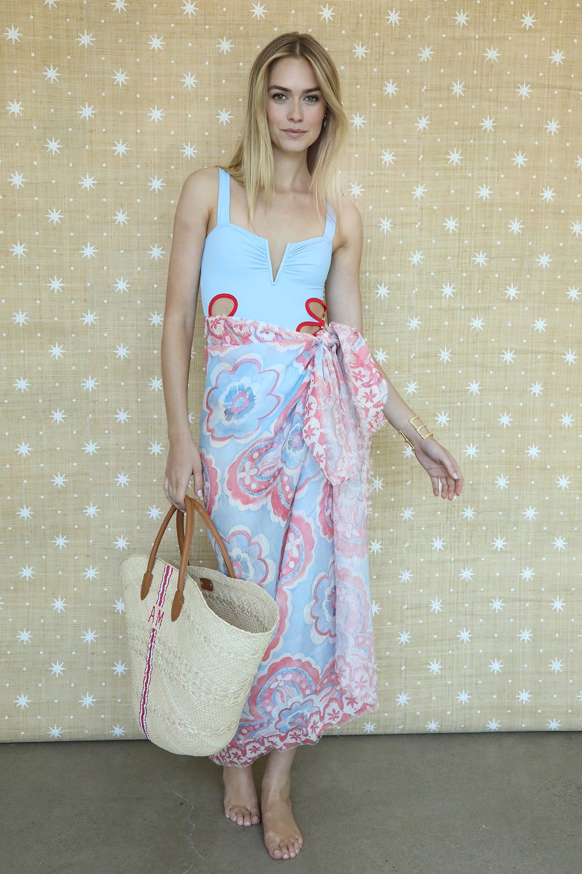 Model wearing Americana Willow pareo, showing hand-painted red, white and blue clover motif and fringed edge