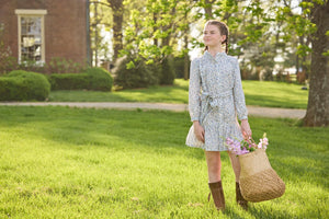 Little English traditional children's clothing. Long sleeve blue, brown, and cream floral shirt dress with tie sash for older girls.