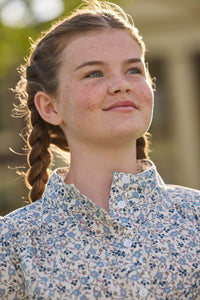 Little English traditional children's clothing. Long sleeve blue, brown, and cream floral shirt dress with tie sash for older girls.