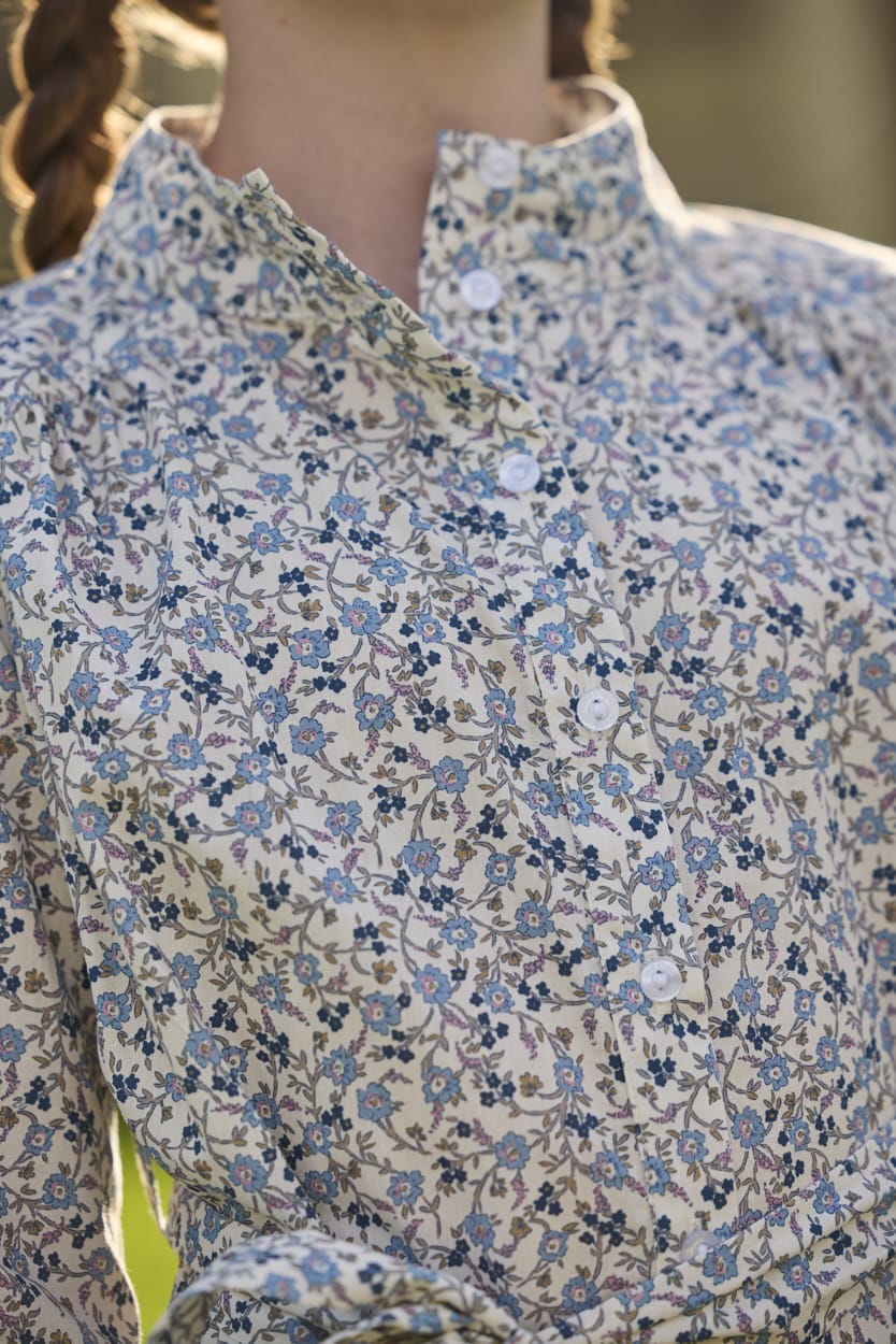 Little English traditional children's clothing. Long sleeve blue, brown, and cream floral shirt dress with tie sash for older girls.