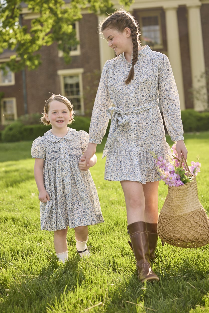 Little English traditional children's clothing. Capped sleeve blue, brown, and cream floral smocked dress with peter pan collar for little girls.