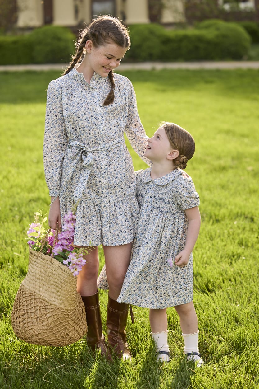 Little English traditional children's clothing. Long sleeve blue, brown, and cream floral shirt dress with tie sash for older girls.