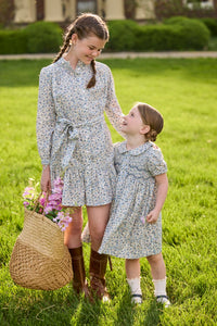 Little English traditional children's clothing. Capped sleeve blue, brown, and cream floral smocked dress with peter pan collar for little girls.