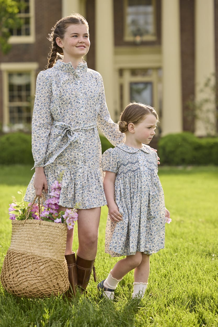 Little English traditional children's clothing. Capped sleeve blue, brown, and cream floral smocked dress with peter pan collar for little girls.